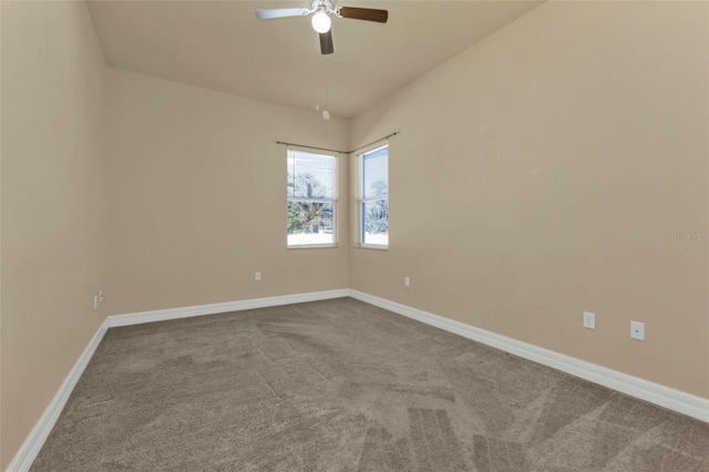 carpeted spare room featuring ceiling fan