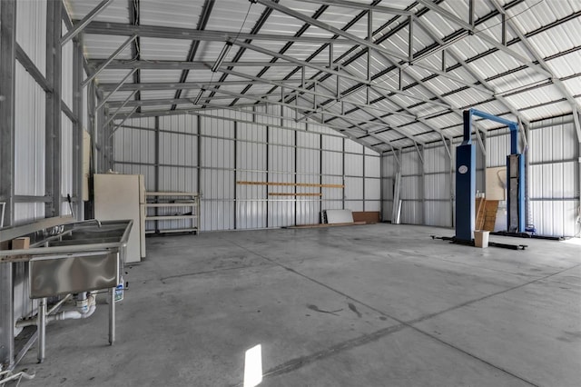 garage with metal wall and freestanding refrigerator