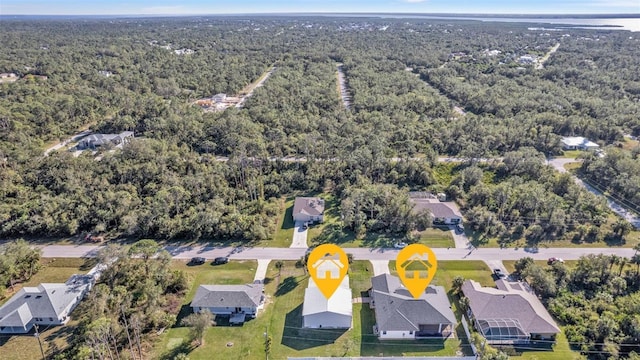 aerial view with a wooded view and a residential view