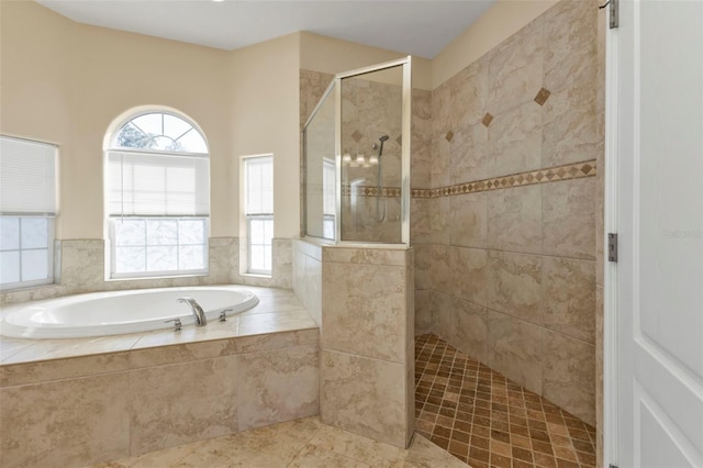 bathroom featuring a bath, tile patterned floors, and walk in shower