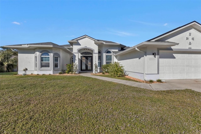 view of front of house featuring a garage, stucco siding, french doors, and a front yard