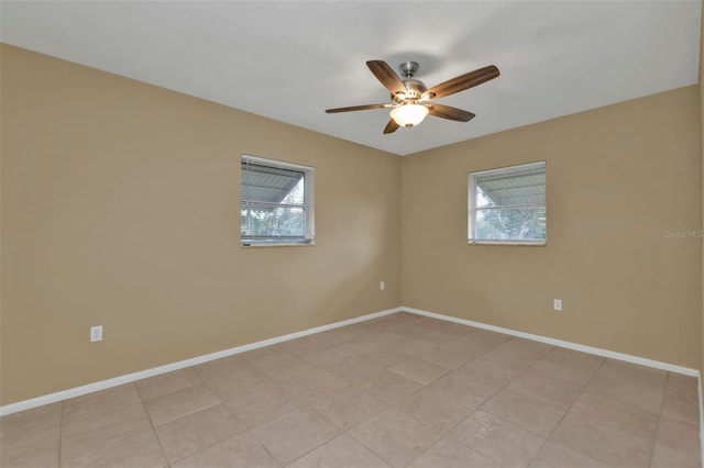 unfurnished room with a wealth of natural light and ceiling fan