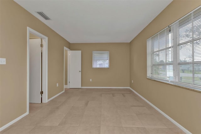 unfurnished room featuring light tile patterned flooring