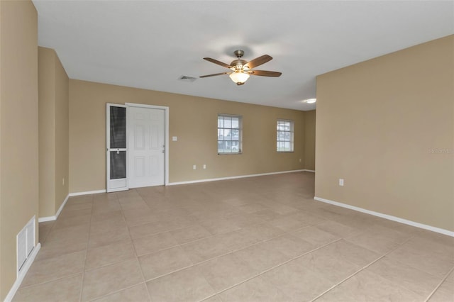 tiled spare room featuring ceiling fan