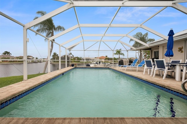 view of pool featuring a patio, a water view, and a lanai