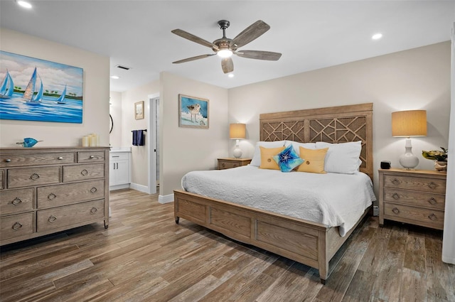 bedroom featuring ceiling fan, dark hardwood / wood-style floors, and ensuite bathroom