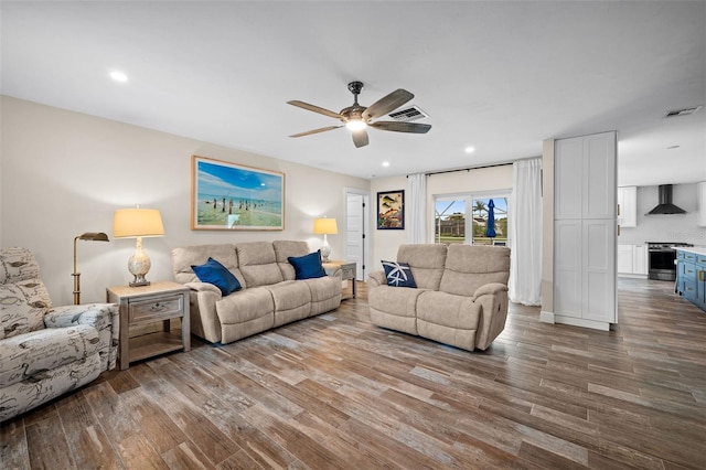 living room featuring wood-type flooring and ceiling fan