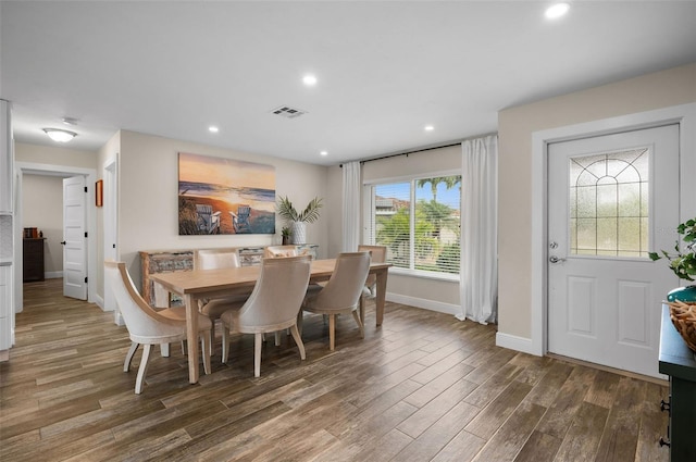 dining room featuring dark wood-type flooring and a healthy amount of sunlight