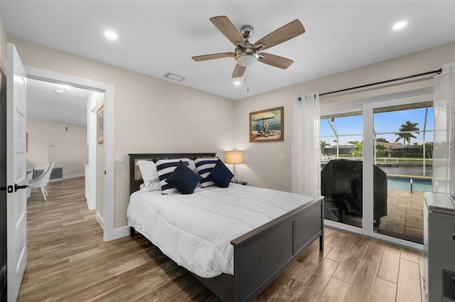 bedroom featuring dark hardwood / wood-style flooring, access to outside, and ceiling fan