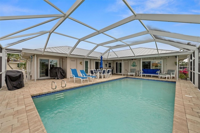 rear view of property with a lanai and a patio area