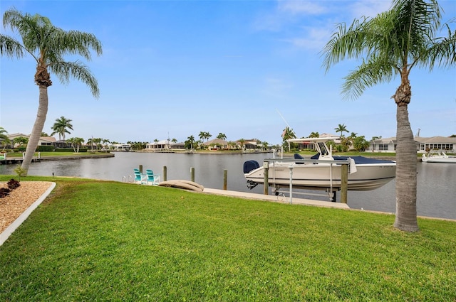 dock area with a water view and a lawn