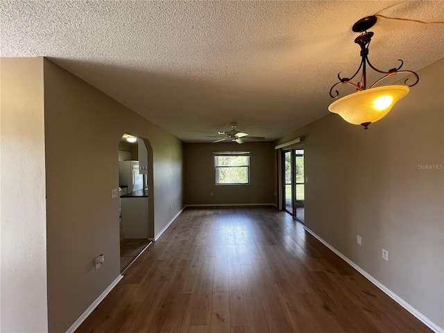 interior space with dark hardwood / wood-style flooring, a textured ceiling, and ceiling fan