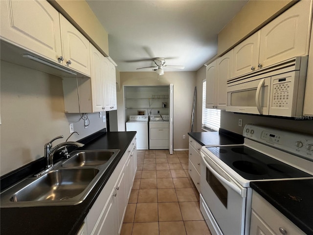 kitchen with white cabinets, white appliances, washer and dryer, and sink