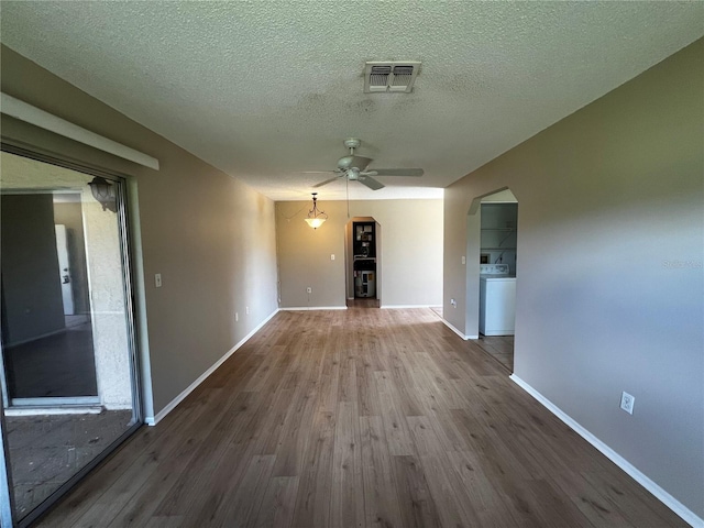 interior space featuring hardwood / wood-style floors, ceiling fan, a textured ceiling, and washer / clothes dryer