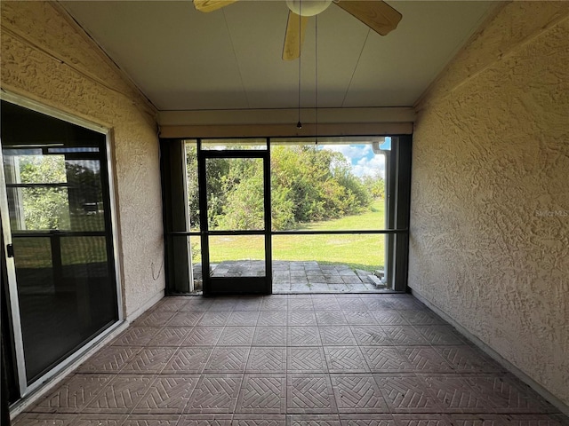 unfurnished sunroom with ceiling fan and lofted ceiling