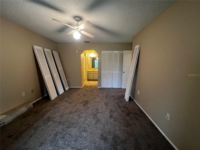 unfurnished bedroom featuring a textured ceiling, ceiling fan, and carpet floors