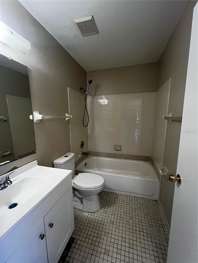 full bathroom featuring vanity, tile patterned floors, toilet, and tiled shower / bath