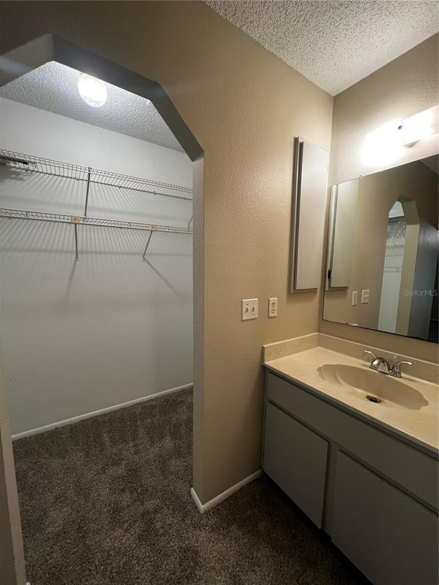 bathroom with vanity and a textured ceiling