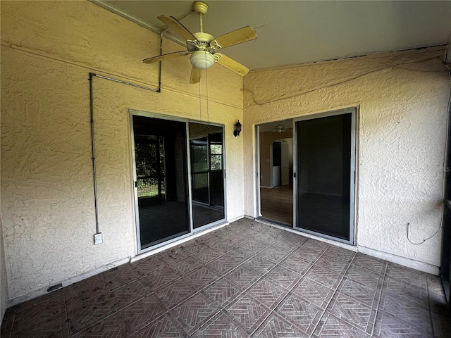 view of patio featuring ceiling fan