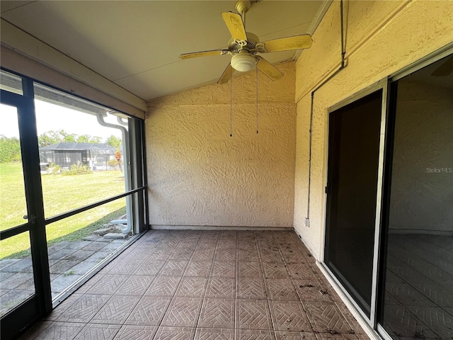 unfurnished sunroom featuring lofted ceiling and ceiling fan