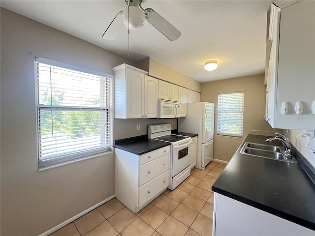 25068 Harborview Rd Unit 1A, Punta Gorda, FL 33980 - kitchen featuring white appliances, a sink, dark countertops, white cabinetry, and a ceiling fan