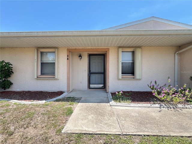 25068 Harborview Rd Unit 1A, Punta Gorda, FL 33980 - view of exterior entry featuring stucco siding