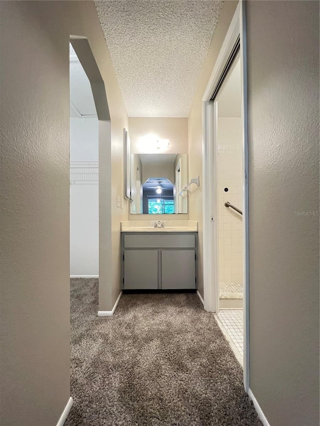 25068 Harborview Rd Unit 1A, Punta Gorda, FL 33980 - hallway with carpet floors, a textured ceiling, baseboards, and a textured wall