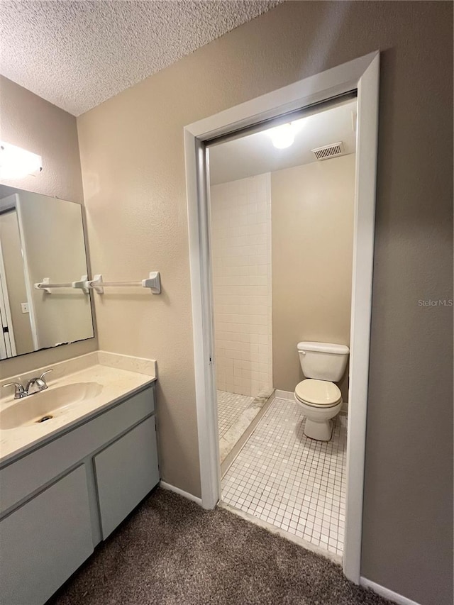 25068 Harborview Rd Unit 1A, Punta Gorda, FL 33980 - bathroom featuring toilet, a shower stall, vanity, and a textured ceiling