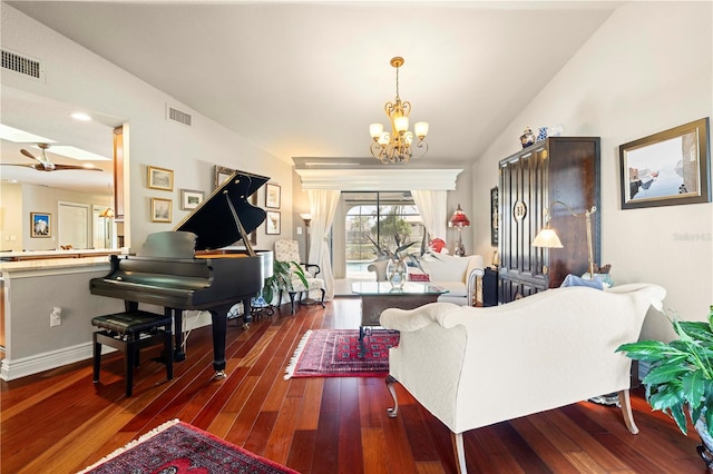 living room with dark hardwood / wood-style flooring, lofted ceiling, and an inviting chandelier