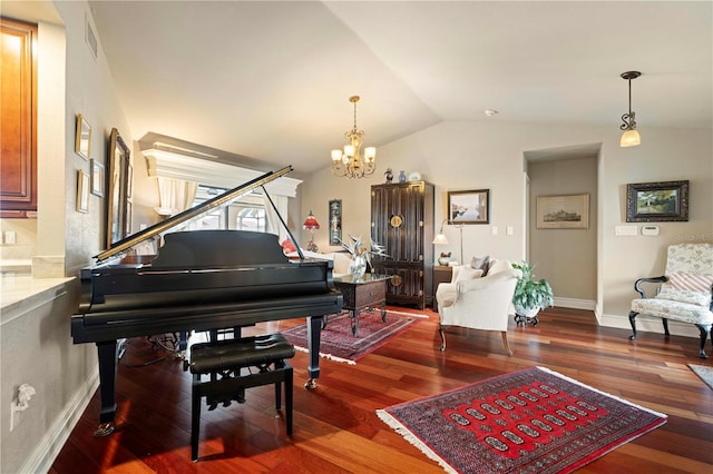 sitting room with a notable chandelier, dark wood-type flooring, and vaulted ceiling