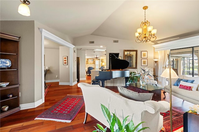 living room featuring a chandelier, dark wood-type flooring, and vaulted ceiling