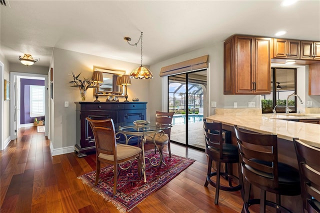 dining room featuring plenty of natural light, sink, and dark hardwood / wood-style floors