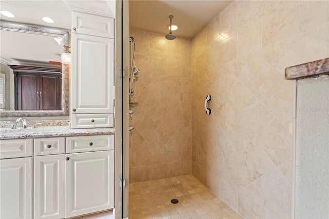 bathroom featuring vanity and a tile shower