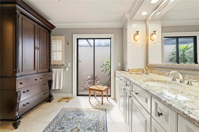 bathroom with ornamental molding and vanity