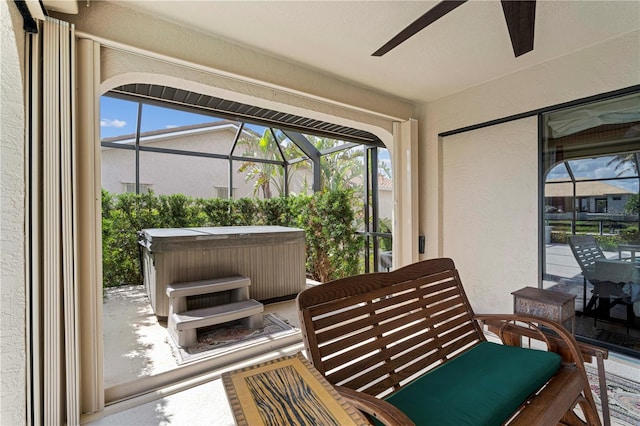 sunroom / solarium featuring ceiling fan