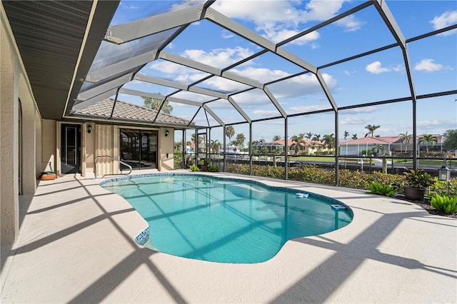 view of pool featuring a patio and glass enclosure