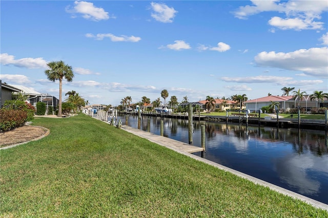 dock area with a water view and a lawn