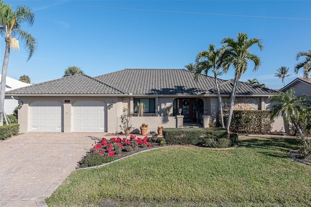 view of front of property with a garage and a front yard