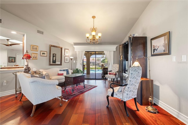 living room featuring an inviting chandelier, lofted ceiling, and dark hardwood / wood-style floors