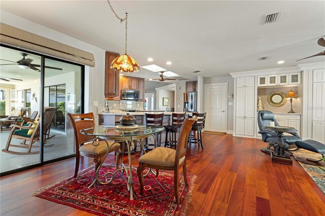 dining room featuring dark hardwood / wood-style floors and ceiling fan