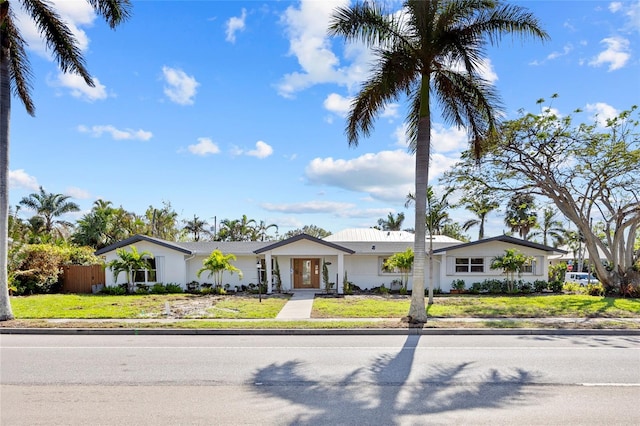 ranch-style home with a front lawn