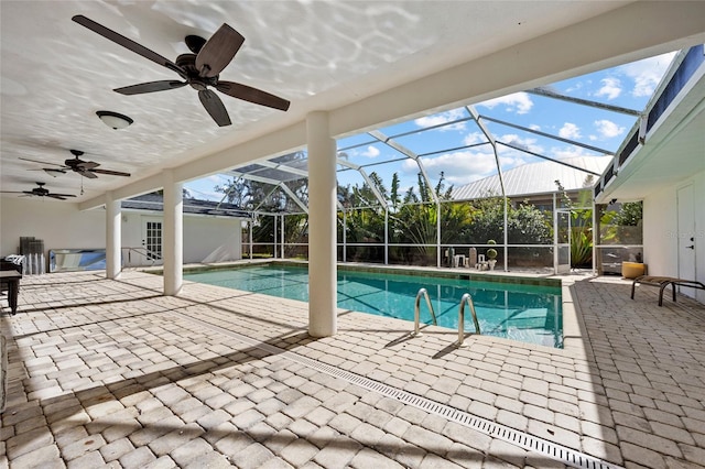 view of pool with a lanai, ceiling fan, and a patio area