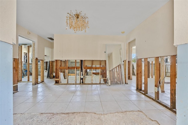 interior space with a chandelier and light tile patterned flooring