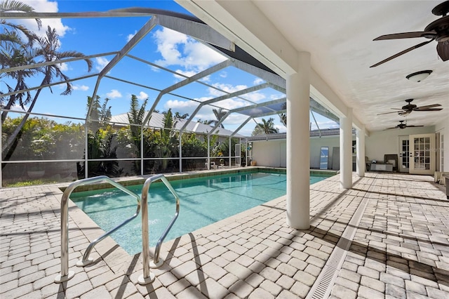 view of pool with french doors, glass enclosure, a patio, and ceiling fan