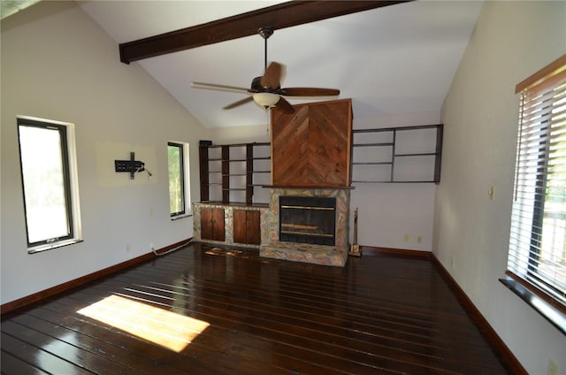 unfurnished living room featuring beam ceiling, a stone fireplace, ceiling fan, and dark hardwood / wood-style flooring