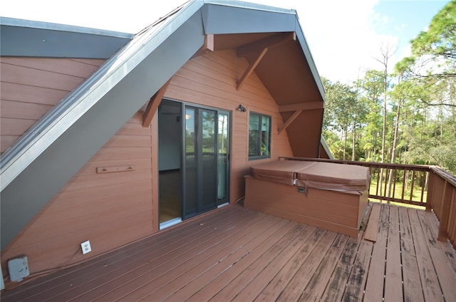 wooden terrace with a covered hot tub