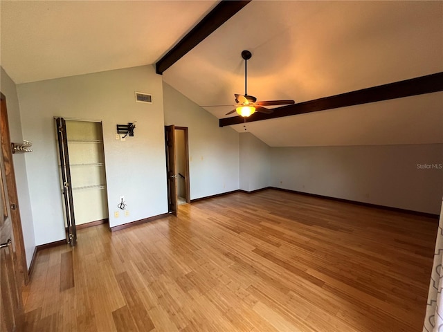 additional living space with lofted ceiling with beams, light hardwood / wood-style flooring, and ceiling fan