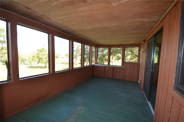 unfurnished sunroom with wooden ceiling