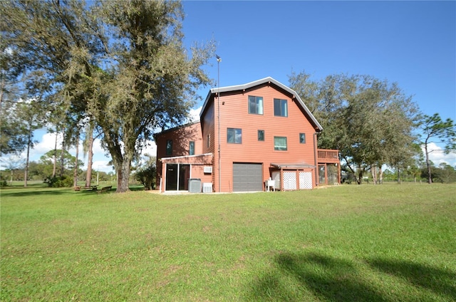 view of side of property featuring a yard, a deck, and a garage