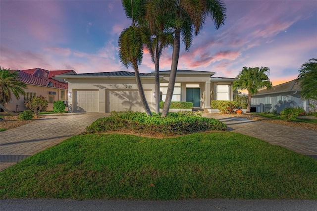 single story home with a yard and a garage